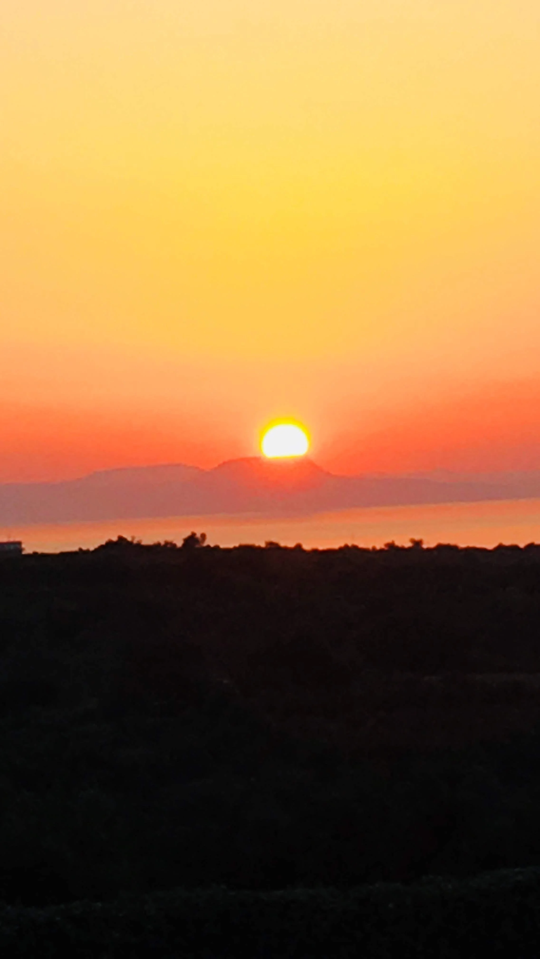 Quiet sunset over distant hills